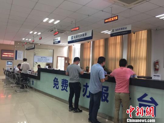 绍兴车管所内市民正在免费代办服务台咨询 陈洁 摄 绍兴车管所内市民正在免费代办服务台咨询 陈洁 摄